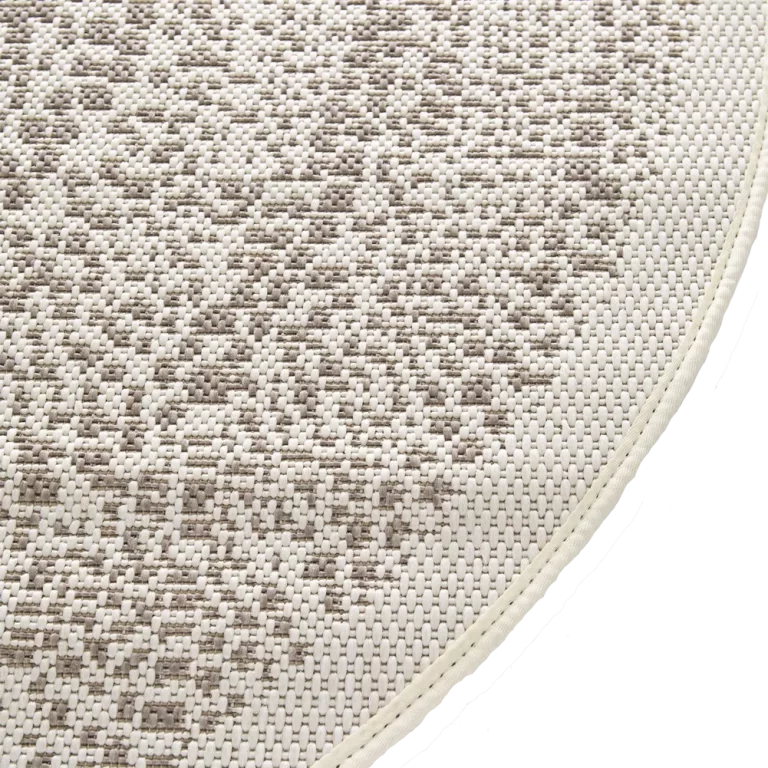 Close-up of a textured beige and brown rug corner