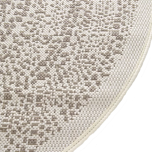 Close-up of a textured beige and brown rug corner