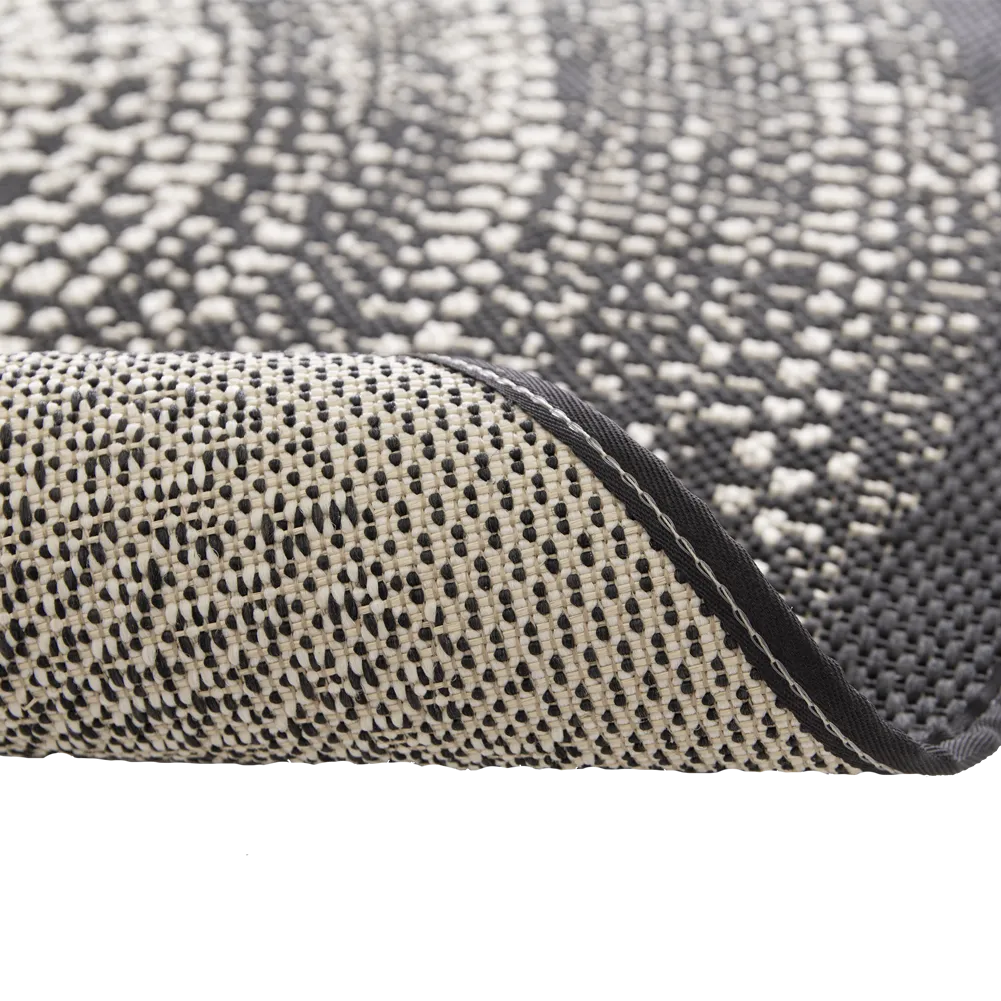 Close-up of a textured rug with a geometric pattern on a white background