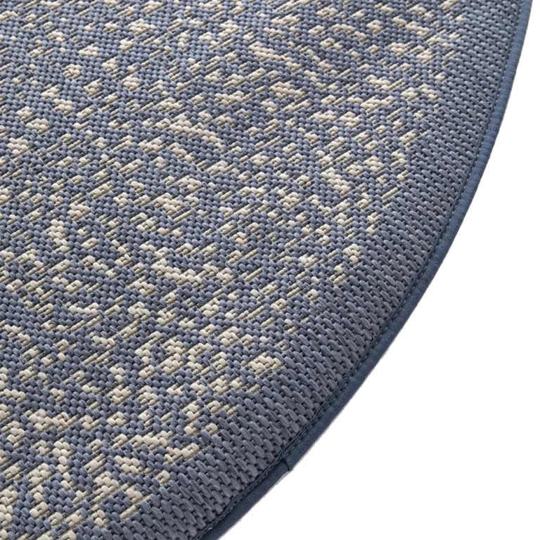 Close-up of a textured blue rug with a geometric pattern on a white background