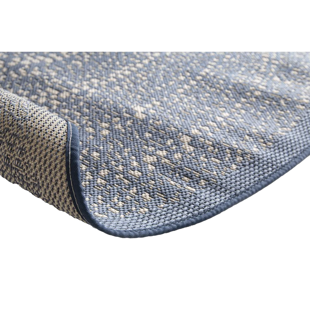 Close-up of a textured blue rug with a white background