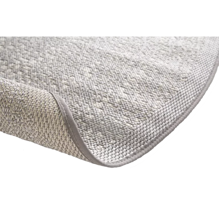 Close-up of a textured gray bath mat on a white background