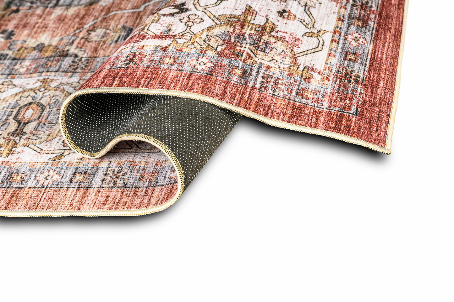 Close-up of a patterned rug with a non-slip backing on a white background