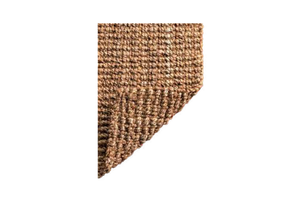 Corner of a textured brown rug on a white background