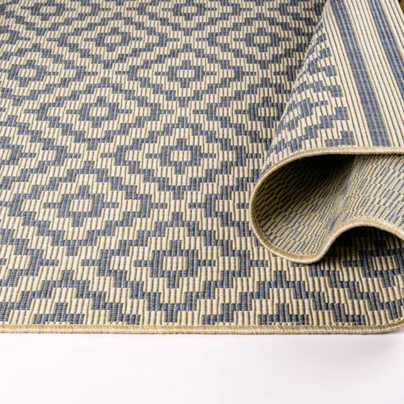 Patterned rug with geometric design on a white background