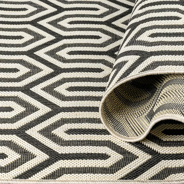 Close-up of a black and white geometric patterned rug.