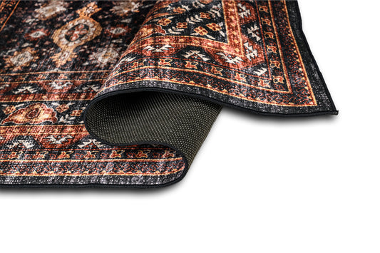 Close-up of a patterned rug with a textured border on a white background