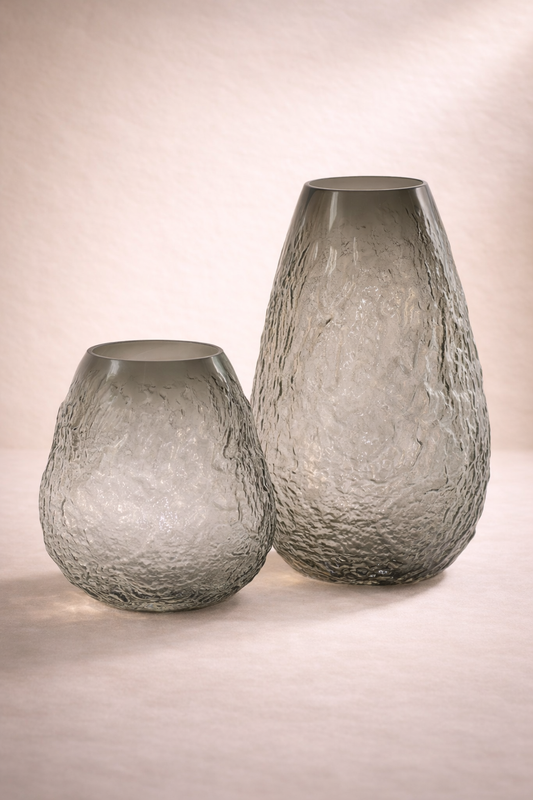 Two textured glass vases on a neutral background