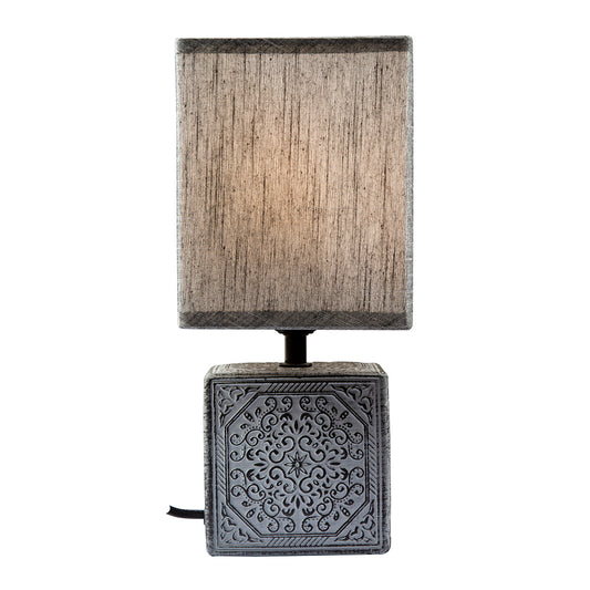 Table lamp with decorative base and rectangular fabric shade on a white background