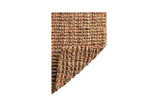Corner of a textured brown rug on a white background