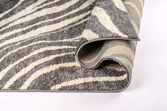 Roll of patterned rug with gray and beige stripes on a white background