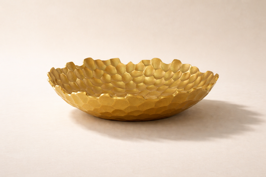 Gold textured bowl on a beige background