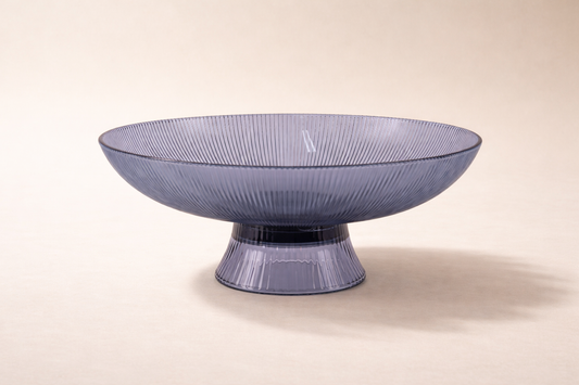 Decorative glass bowl with textured design on a beige background