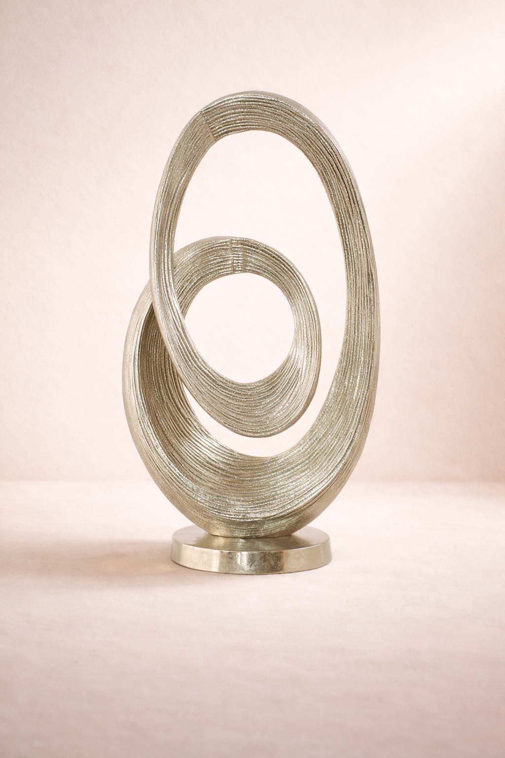 Decorative sculpture with interlocking circular designs on a beige background
