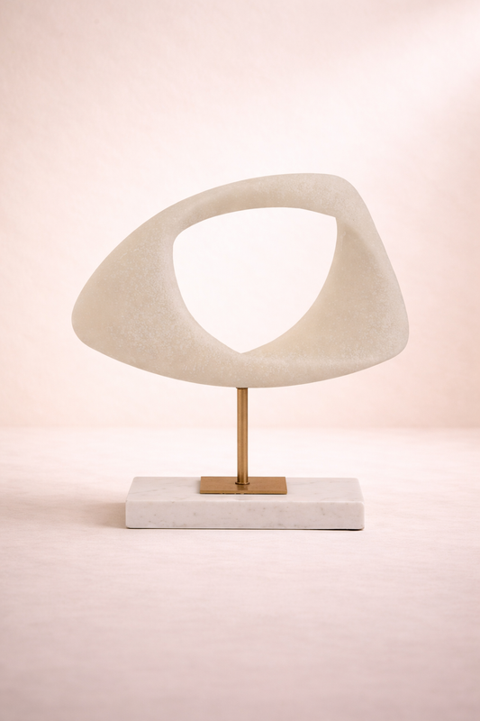 Decorative sculpture with a geometric design on a pink background