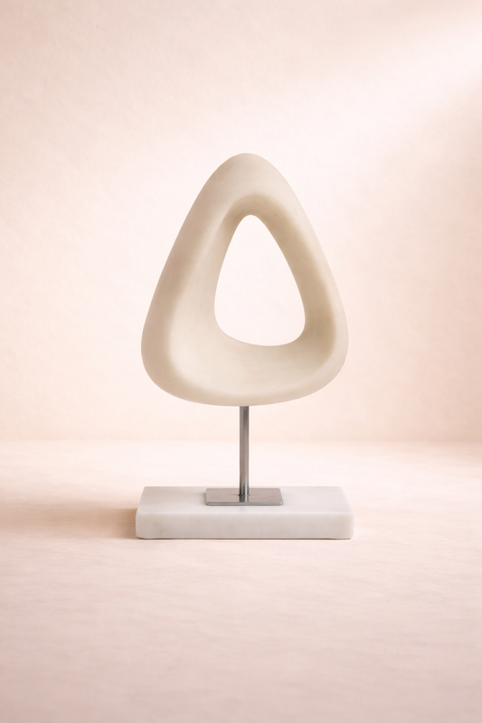 Modern table lamp with a unique white design on a soft pink background