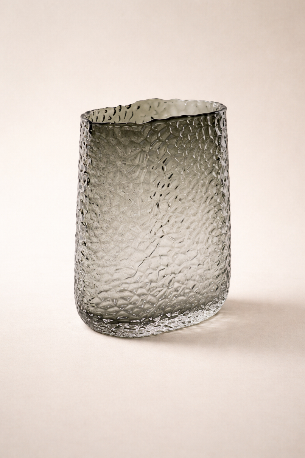 Textured glass vase on a beige background
