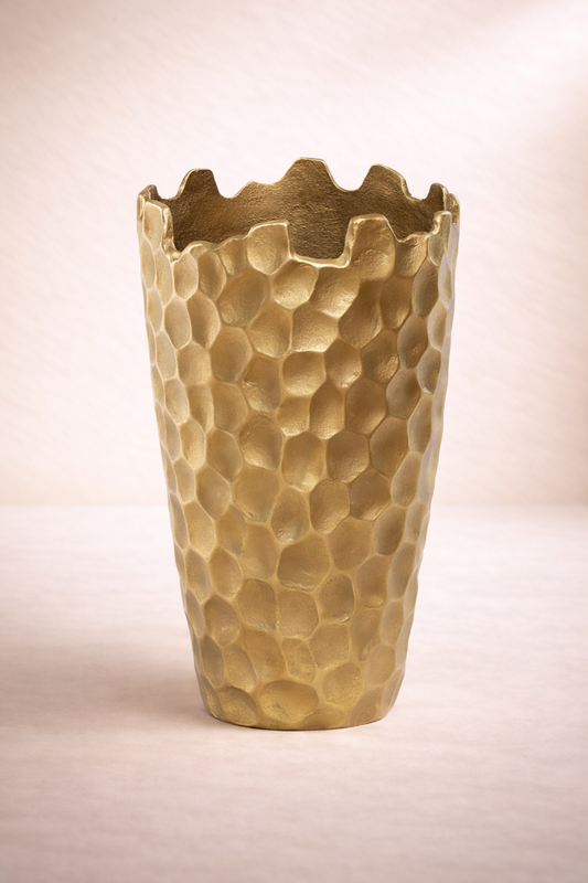 Gold textured vase on a light beige background