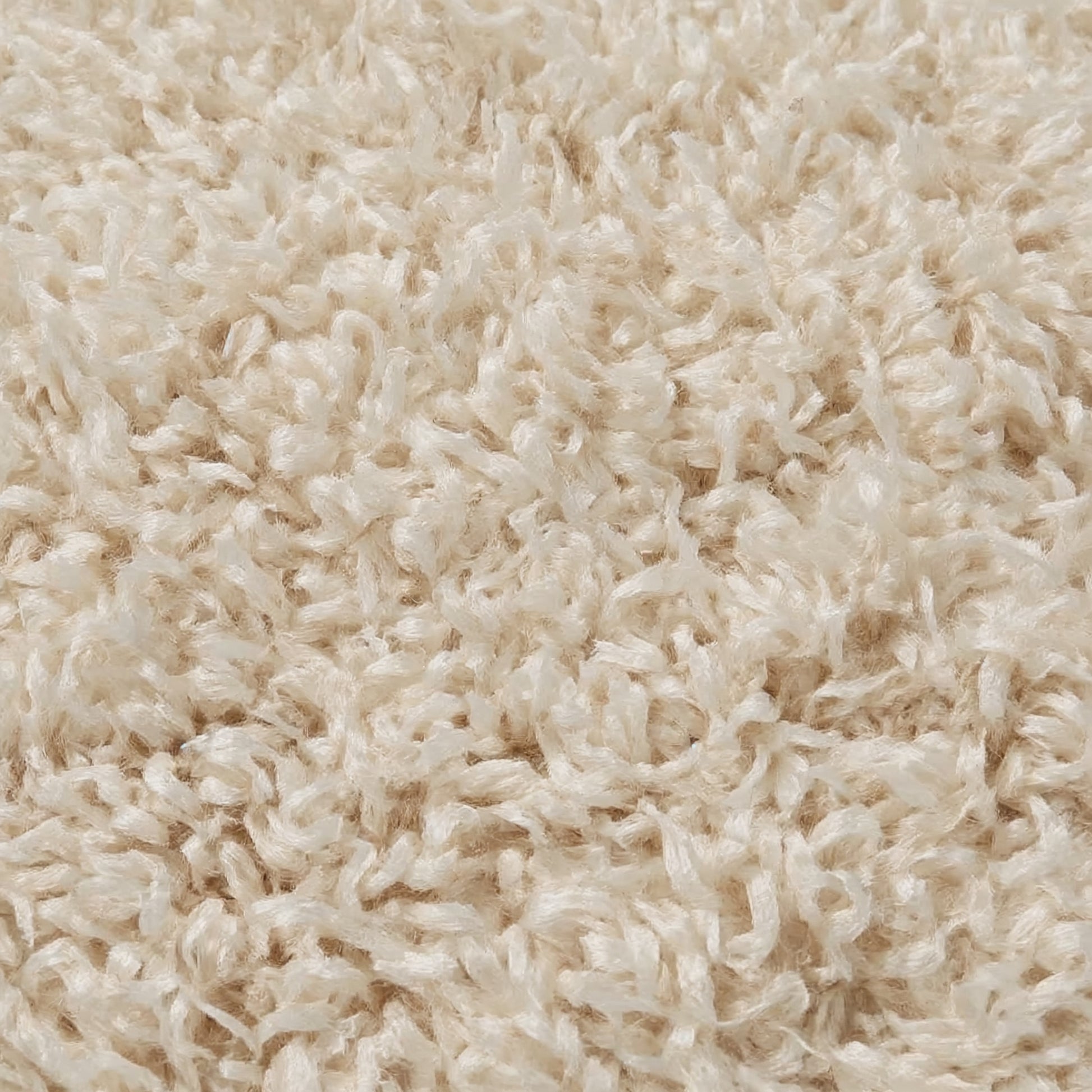 Close-up of beige shaggy carpet texture