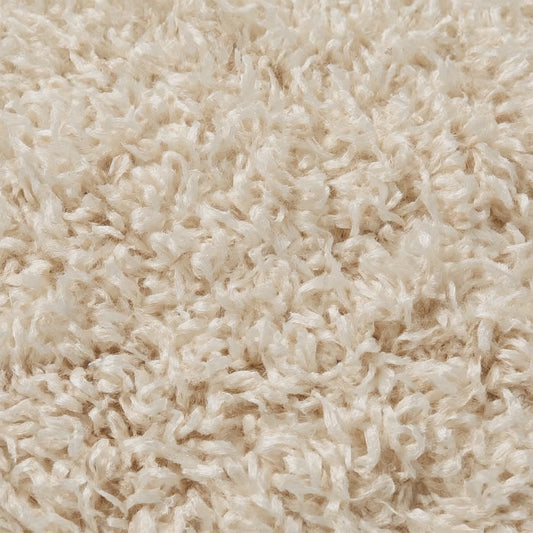 Close-up of beige shaggy carpet texture